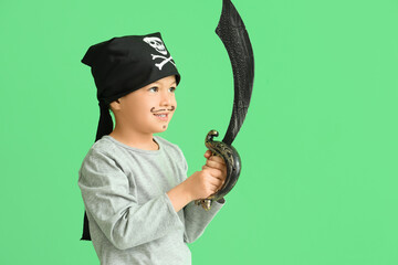 Cute little pirate with sword on green background