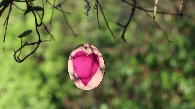 Homemade love heart decoration in the wind in the garden during Valentine's day