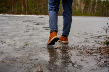 Person walking carefully on thin ice across a frozen lake, winter landscape, risky adventure, caution in nature