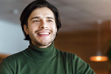 Obraz premium Excited blogger full of creative ideas working online at cafe, holding digital tablet, drinking coffee or tea, copy space