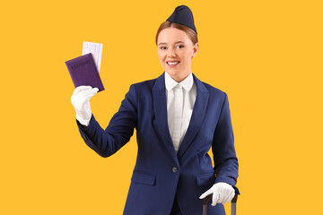 Young stewardess with passport on yellow background