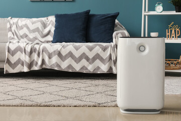 Modern air purifier in interior of living room
