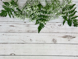 Greens in white, wooden background
