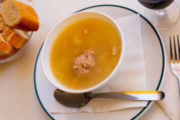 Delicious nutritious soup with pasta, meatballs, potato slices and chickpeas. Typical dish of Catalonia and Murcia