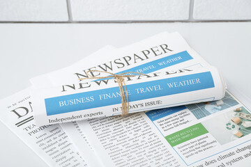 Different newspapers on white table