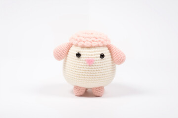 A crocheted sheep toy on a  white background.	

