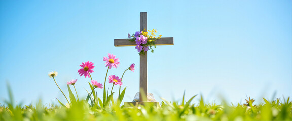 Obraz premium Cross adorned with vibrant spring flowers in peaceful meadow, remembrance