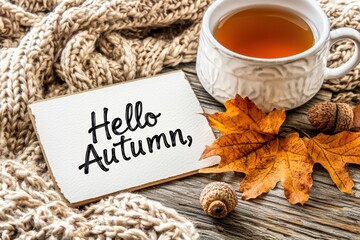 Naklejka premium Cozy vintage postcard welcoming autumn with golden leaves, tea, and elegant calligraphy