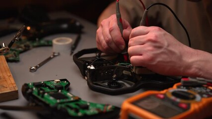 Electronic technician measuring drone circuitry with multimeter, surrounded by repair tools and spare parts on cluttered workshop workbench. Concept of professional electronics troubleshooting skills. - Powered by Adobe