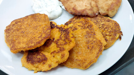 Savory Potato Pancakes Served With Creamy Dipping Sauce and Crispy Sides in a Cozy Setting