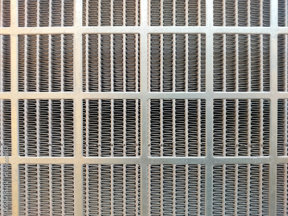 Poster stainless steel mesh showcasing intricate patterns under soft natural light in an industrial setting