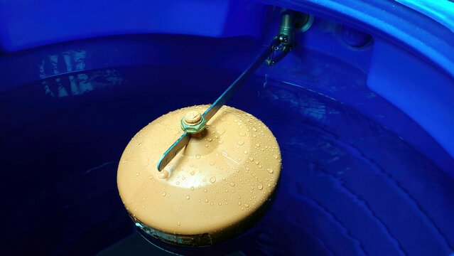 Water Valve Float Buoyantly Regulating Level in a Tranquil Blue Tank