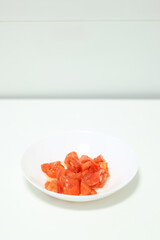 Healthy food. A plate of cut natural tomato.