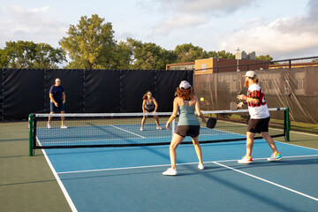 Four Pickleball Players Hitting