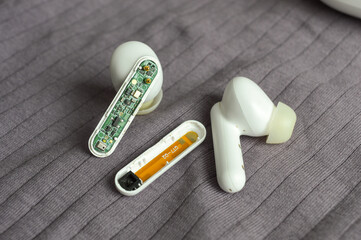 internal circuitry of a wireless earbud tech guides repair internal components disassemble troubleshoot electronics manufacturing engineering PCB assembly testing teardowns analyze gadgets reviews 
