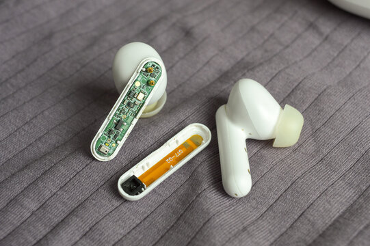 internal circuitry of a wireless earbud tech guides repair internal components disassemble troubleshoot electronics manufacturing engineering PCB assembly testing teardowns analyze gadgets reviews 