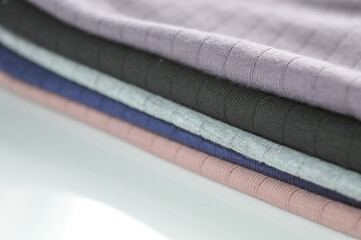 stacked fabric muted tones fashion sustainability material quality textile industry clothing design...