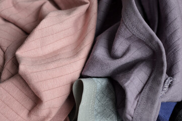 stacked fabric muted tones fashion sustainability material quality textile industry clothing design...