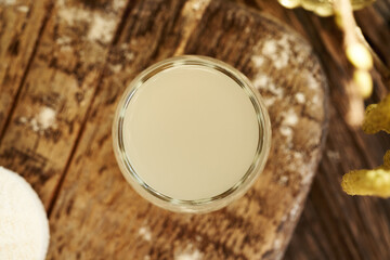 Fresh natural whey in a glass cup, top view