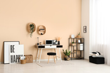 Interior of modern office with workplace, shelf unit and plants