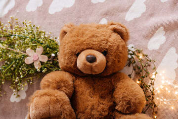 A cute plush teddy bear sitting in a warm, glowing setting with soft bokeh lights, evoking childhood nostalgia.