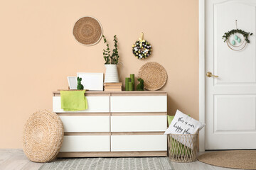 Interior of room decorated for Easter with commode and door