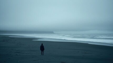 A person strolls along a beach, surfboard in hand, with a scenic view in the background.