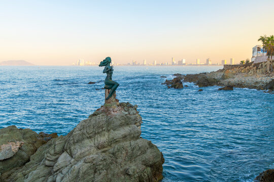 Morning view of the Golden Zone skyline and La Reina de los Mares, or Queen of the Sea, mermaid statue on the Paseo Claussen promenade in Mazatl&aacute;n, Mexico.