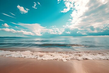 Obraz premium Coastal Serenity: Capturing the tranquil scene where the gentle waves meet the sandy shore under a bright blue sky filled with fluffy clouds, a true depiction of peace and natural beauty.