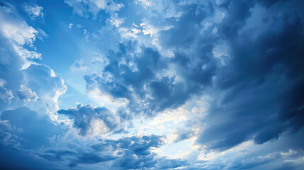 Fototapeta premium beautiful sky filled with clouds, showcasing mix of light and dark shades, creating dramatic atmosphere