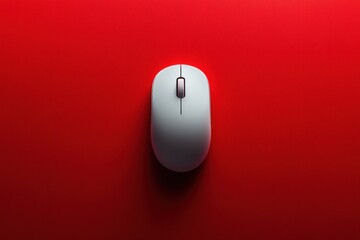 A sleek white computer mouse rests on a vibrant red background showcasing a modern design perfect for minimalist workspace aesthetics