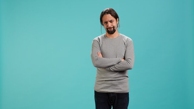 Man shakes head, showing negative emotion, showing lack of satisfaction, isolated over studio background. Irked person disagreeing with friend during conversation, studio backdrop, camera A