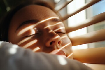 This image features a girl resting peacefully, illuminated by natural light, with beautiful shadows adding depth and emotion to her serene expression.