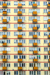 Old obsolete block building with yellow balconies. Soviet architecture in Europe, poor living conditions