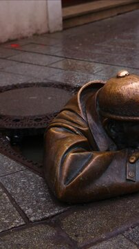 vertical Cumil, the iconic man at work statue peeking from manhole in Bratislava