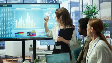 Team of company analysts reviews feedback on sales and orders to work on improvements, developing marketing and PR strategies in meeting room. Startup enterprise affiliates. Camera A.