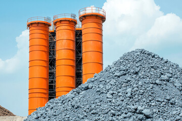 Obraz premium High strength construction materials with orange silos and gray aggregate