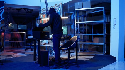 Hacker leaving secret base with SSD in briefcase containing data obtained from victim after...