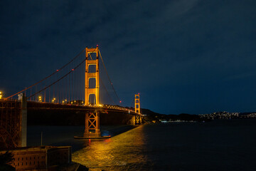 Golden Gate Bridge Illuminated at Night Against the San Francisco Skyline