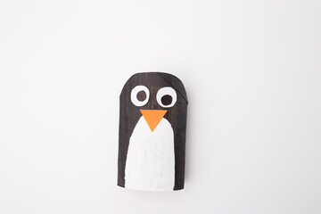 Top view of a paper penguin craft, highlighting creative process steps. Perfect for educational content, art studios, or businesses focusing on crafting and DIY projects. © Elena