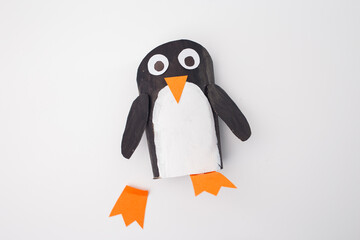 Fototapeta premium A craft representation of a penguin made from paper, showcasing creative progress from above. Ideal for art and craft businesses, educational materials, and DIY project inspiration.