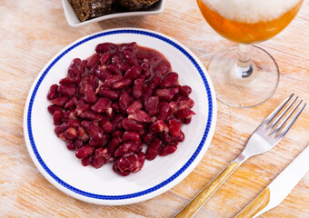 There is ragout of stewed vegetables - red ragout beans on plate. Low-calorie diet lunch, ideas for serving and decorating food.