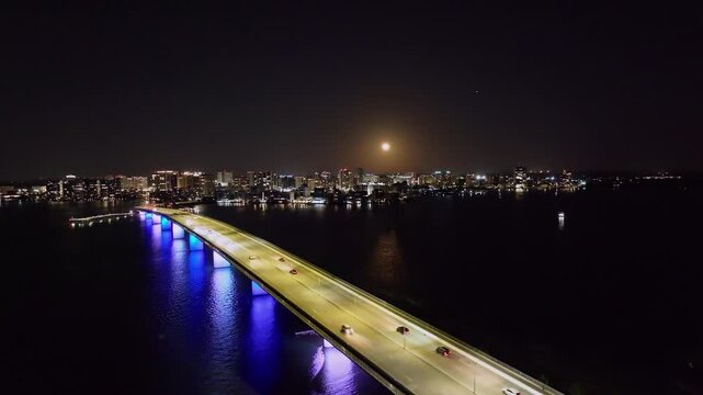 Drone of downtown Sarasota Florida at night over Ringling Causeway Bridge