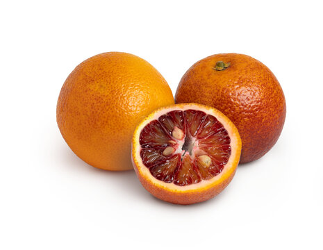 Three blood red oranges with shadow isolated. Full depth of field.