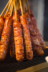 skewers of golden and tempting grilled sausages are neatly arranged