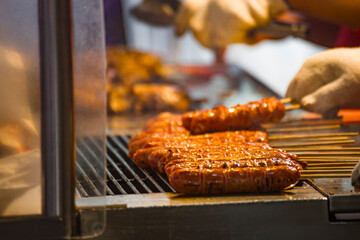 skewers of golden and tempting grilled sausages are neatly arranged