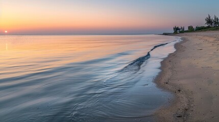 Obraz premium Serene Southeast Asian Beach at Dawn with Calm Waves and Soft Sunrise Colors