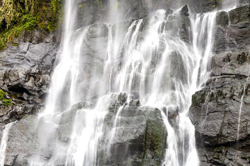 the waterfall cascades down from towering cliffs