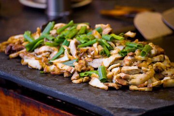 wild boar and scallions are quickly stir-fried on a teppanyaki grill