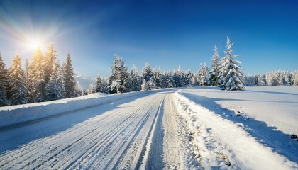 Obraz premium winter road, covered with snow on sunny day